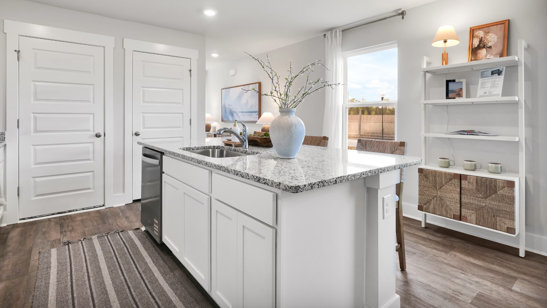 The kitchen features shaker-style cabinets, granite countertops, and stainless-steel appliances, which are sure to both turn heads and make meal prep easy. You’ll never be too far from the action with the living and dining area right there.