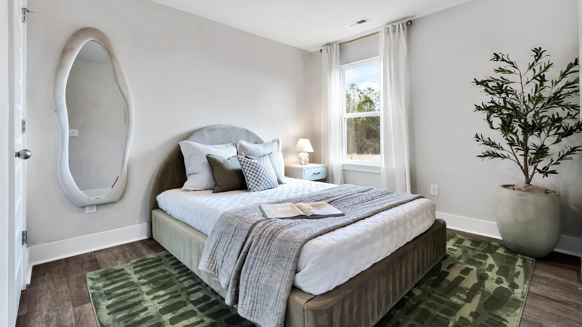 Two other bedrooms share a second bathroom. The laundry room is located at the front of home near the two-car garage, quietly away from living areas and bedrooms.