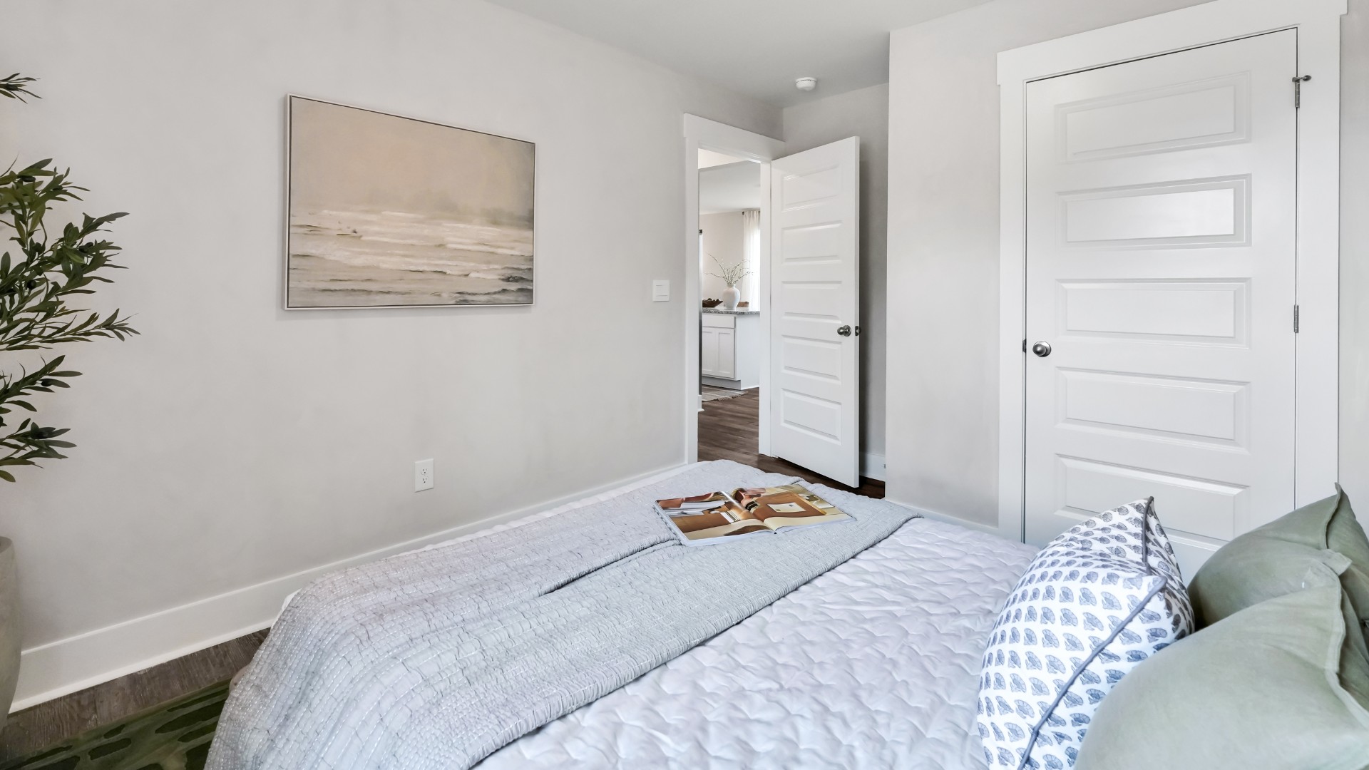 Two other bedrooms share a second bathroom. The laundry room is located at the front of home near the two-car garage, quietly away from living areas and bedrooms.