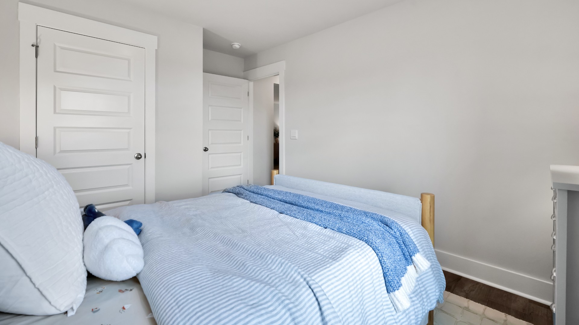 Two other bedrooms share a second bathroom. The laundry room is located at the front of home near the two-car garage, quietly away from living areas and bedrooms.