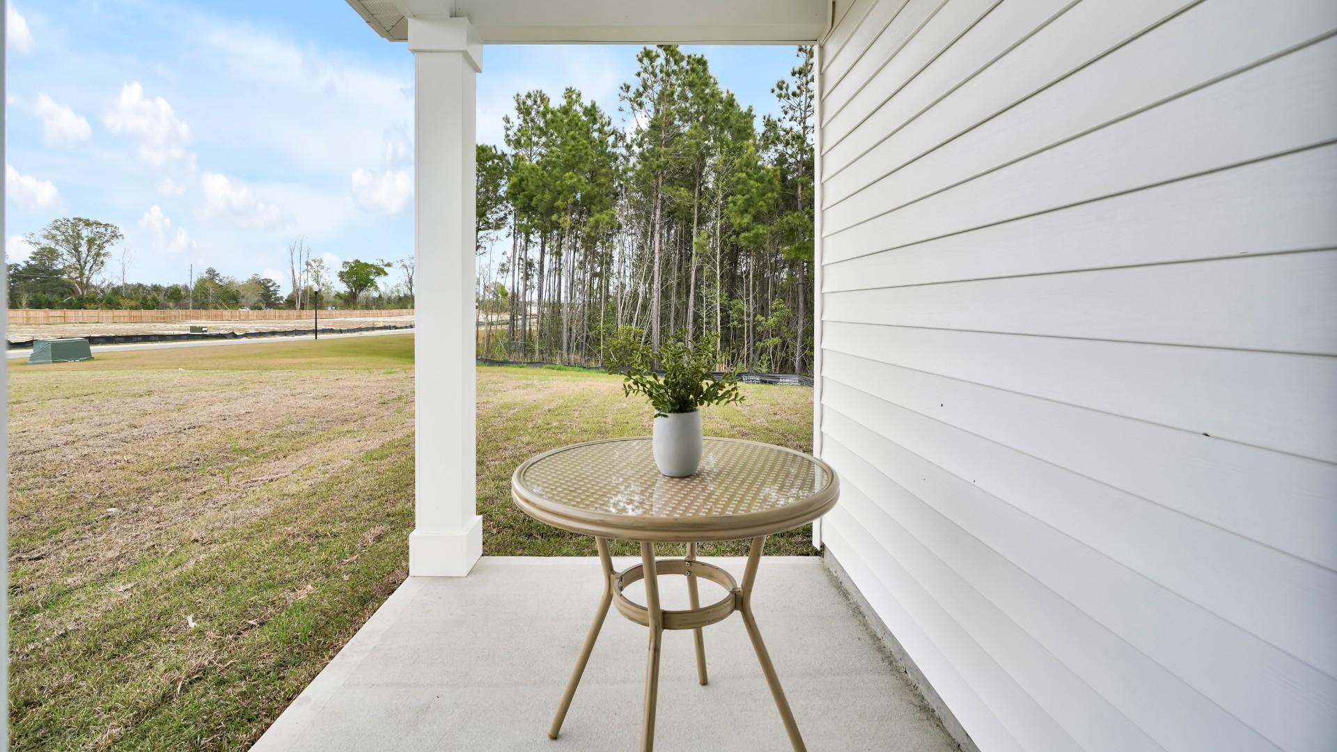 Two other bedrooms share a second bathroom. The laundry room is located at the front of home near the two-car garage, quietly away from living areas and bedrooms.