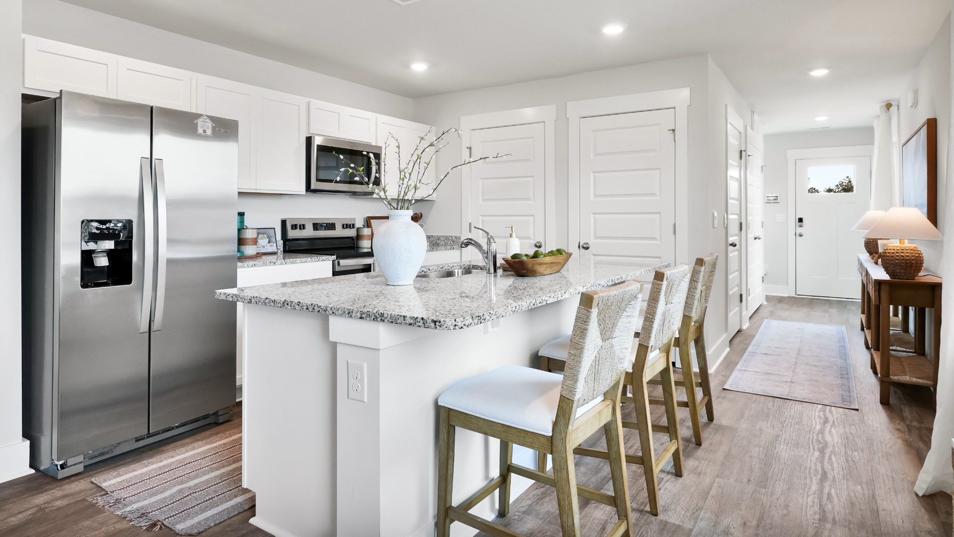 The kitchen features shaker-style cabinets, granite countertops, and stainless-steel appliances, which are sure to both turn heads and make meal prep easy. You’ll never be too far from the action with the living and dining area right there.