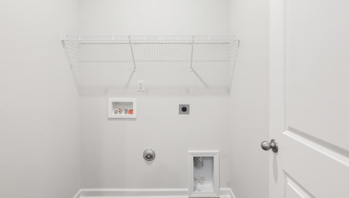 The primary suite is located at the back of the home and includes a walk-in closet and an en-suite bathroom for added comfort