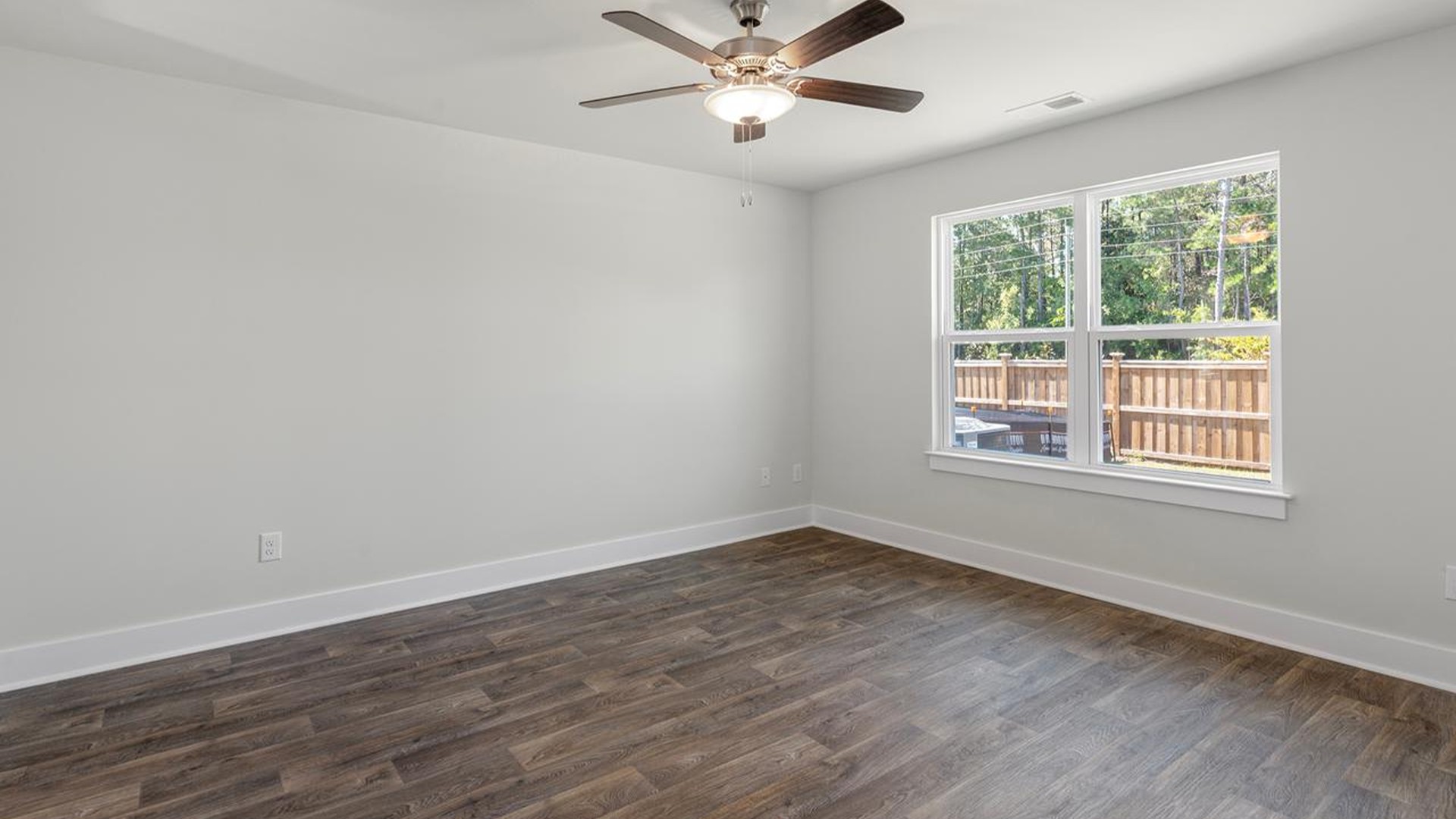 At the back, the primary suite provides privacy with a large walk-in closet and walk-in shower. This floor plan combines comfort and convenience, making it a great choice for those seeking an open layout and a 2-car garage.