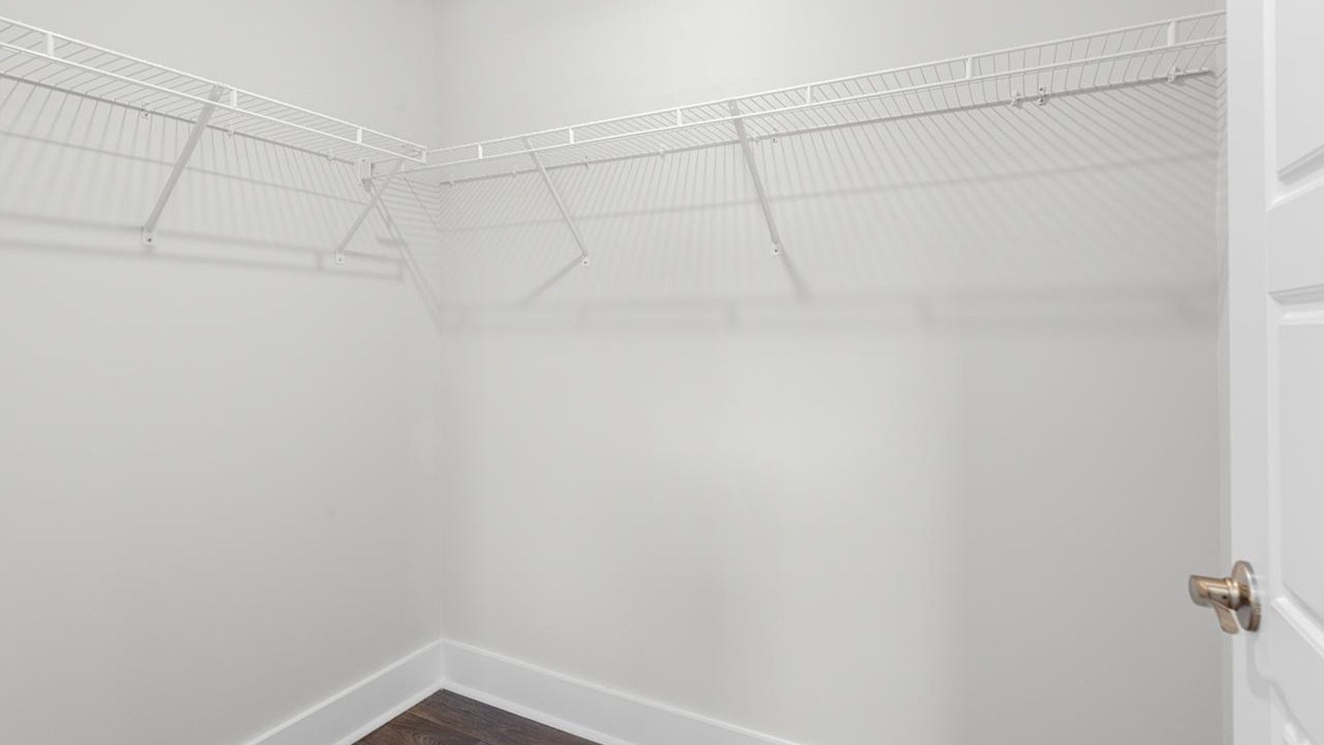 At the back, the primary suite provides privacy with a large walk-in closet and walk-in shower. This floor plan combines comfort and convenience, making it a great choice for those seeking an open layout and a 2-car garage.