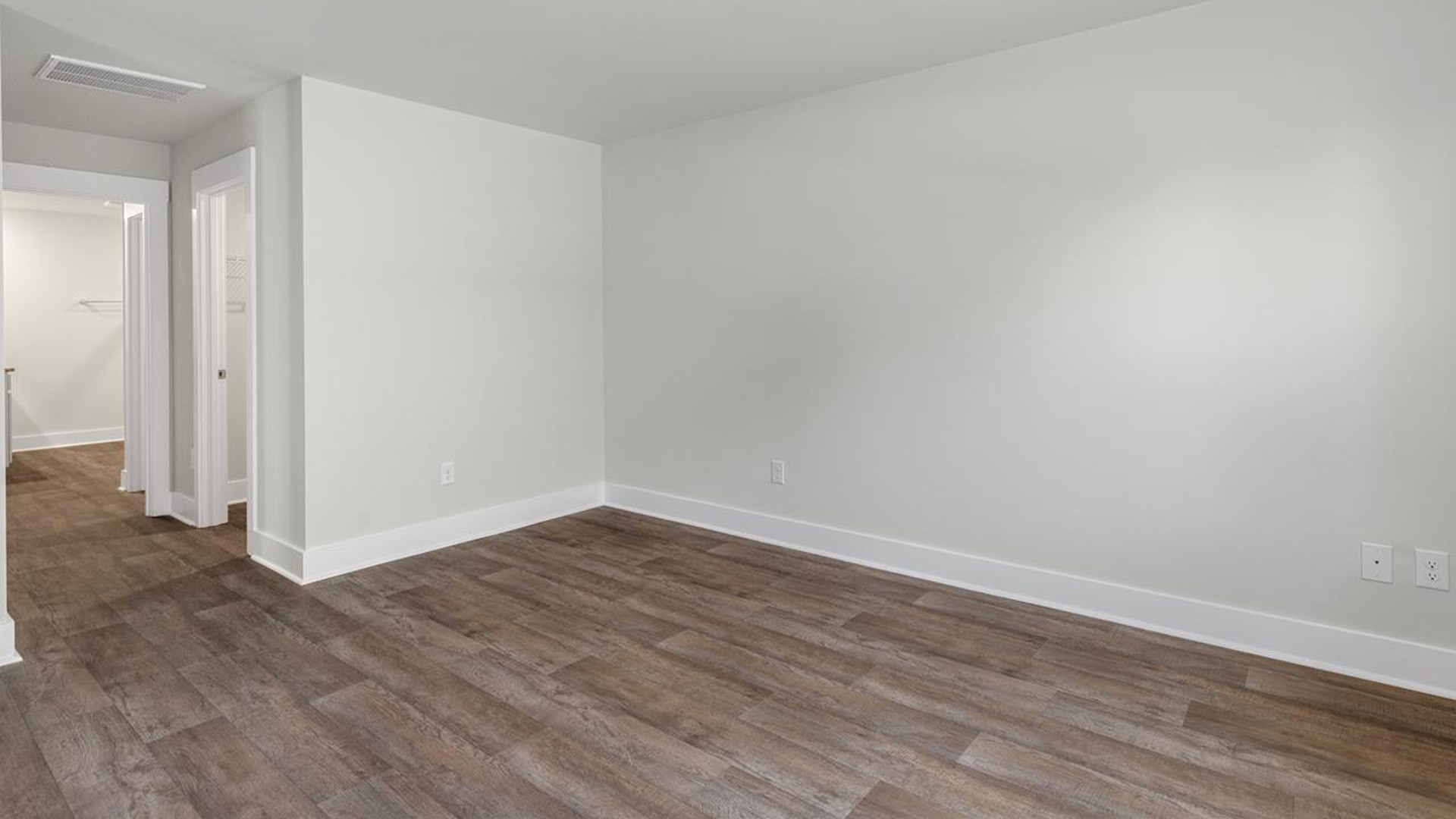 The primary suite offers a massive closet and a luxurious bathroom with a walk-in shower, linen closet, and dual vanity.