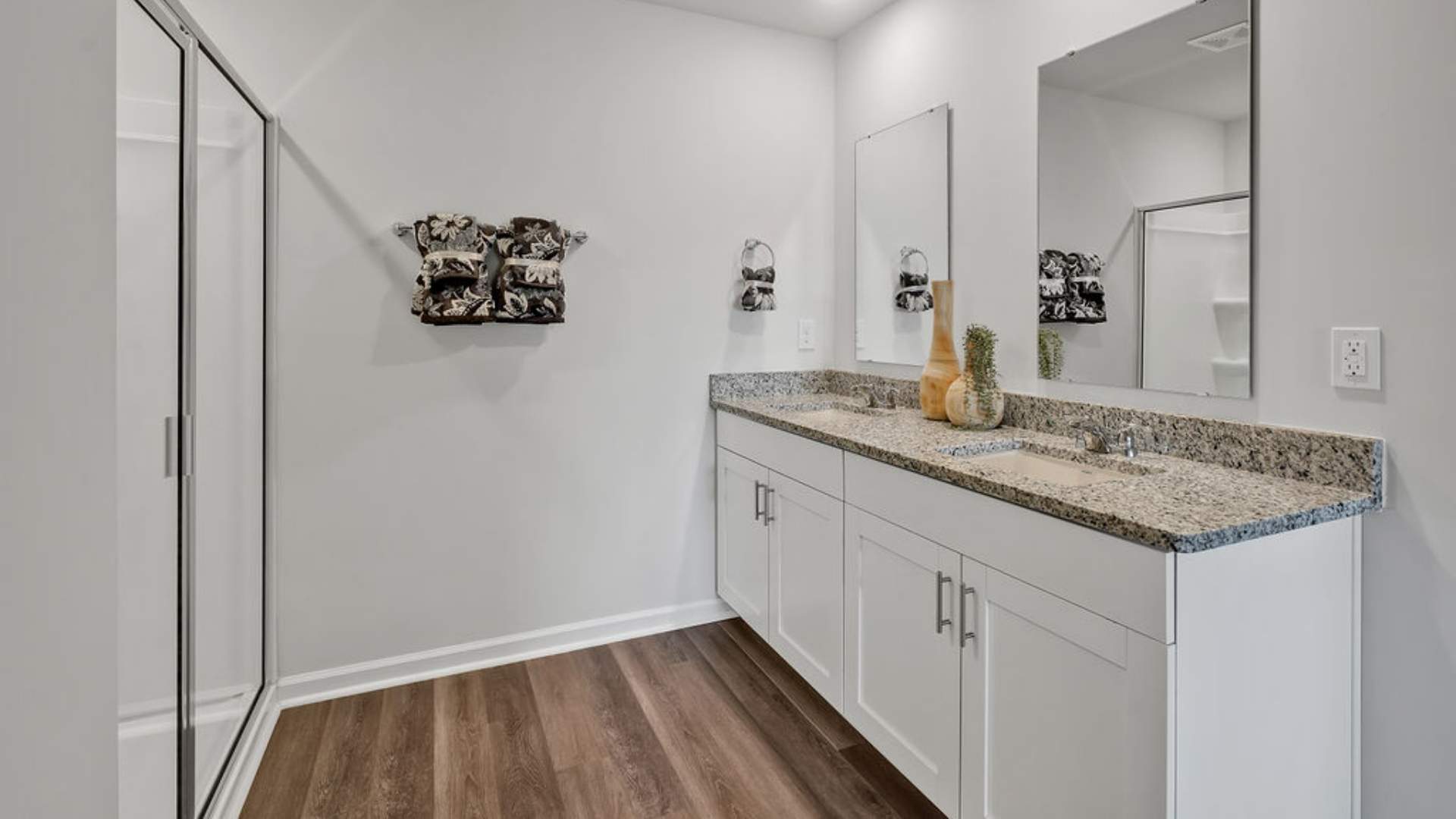The primary suite offers a massive closet and a luxurious bathroom with a walk-in shower, linen closet, and dual vanity.