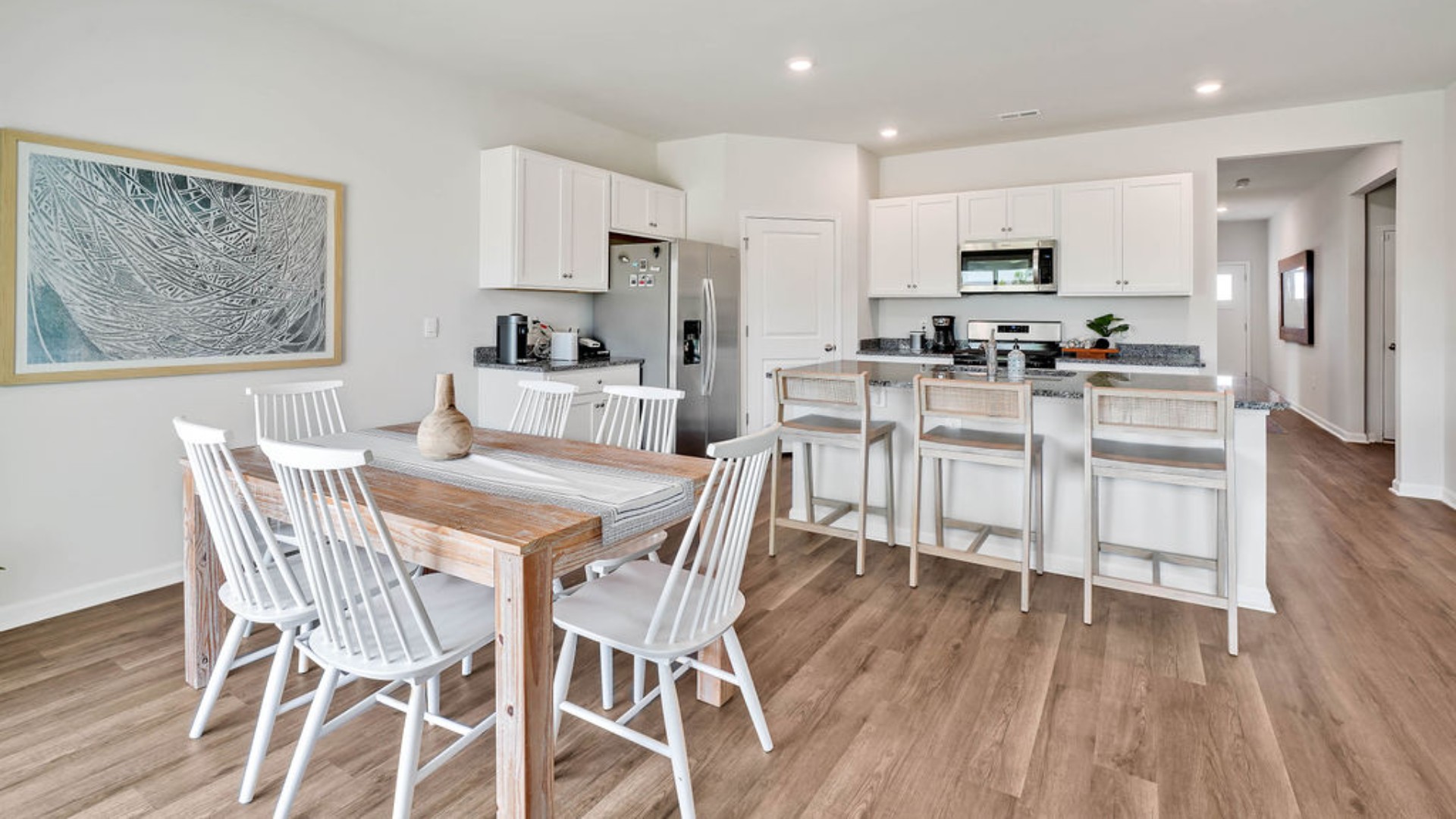 The kitchen features beautiful cabinets, granite countertops, and stainless-steel appliances, which are sure to both turn heads and make meal prep easy. You’ll never be too far from the action with the living and dining area right there.