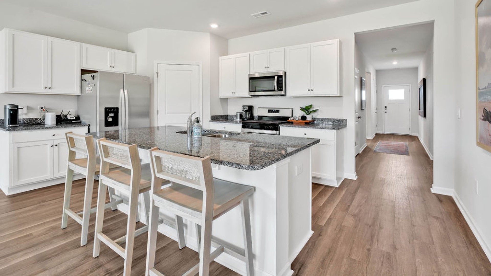 The kitchen features beautiful cabinets, granite countertops, and stainless-steel appliances, which are sure to both turn heads and make meal prep easy. You’ll never be too far from the action with the living and dining area right there.