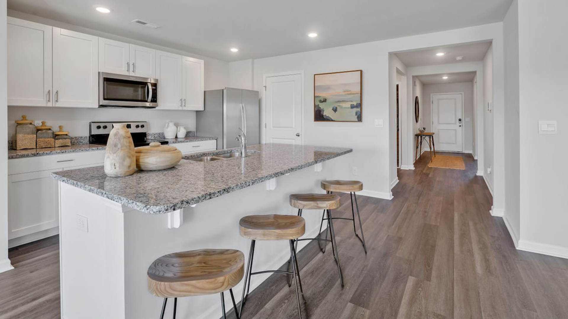 Its centerpiece is the showstopper kitchen, featuring a large island, stainless steel appliances, and a spacious pantry.