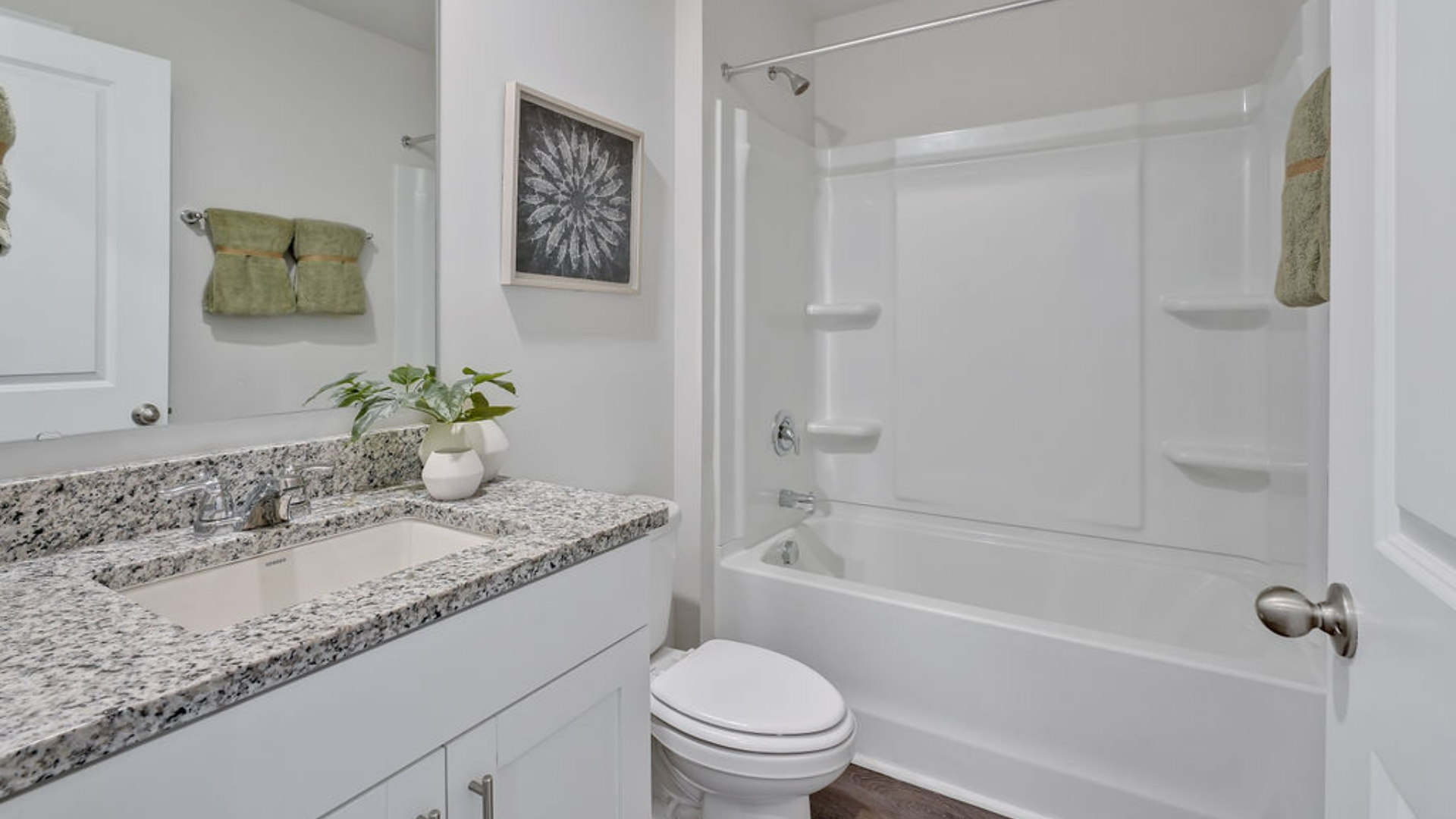 The Primary Suite offers a massive closet and a luxurious bathroom with a walk-in shower, linen closet, and dual vanity.