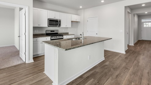 New Homes in Leland, Brunswick Forest community. Our Aria floor plan is complete with granite kitchen countertops, a counter height oversized kitchen island