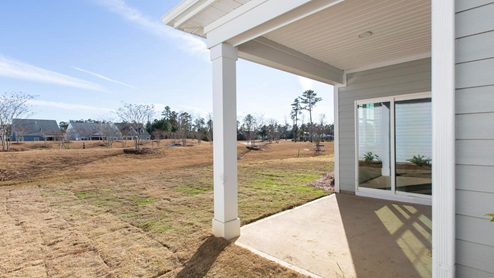 Community of Brunswick Forest in Leland NC. r Aria floor plan is complete with granite kitchen countertops, a counter height oversized kitchen island, quartz bathroom counters