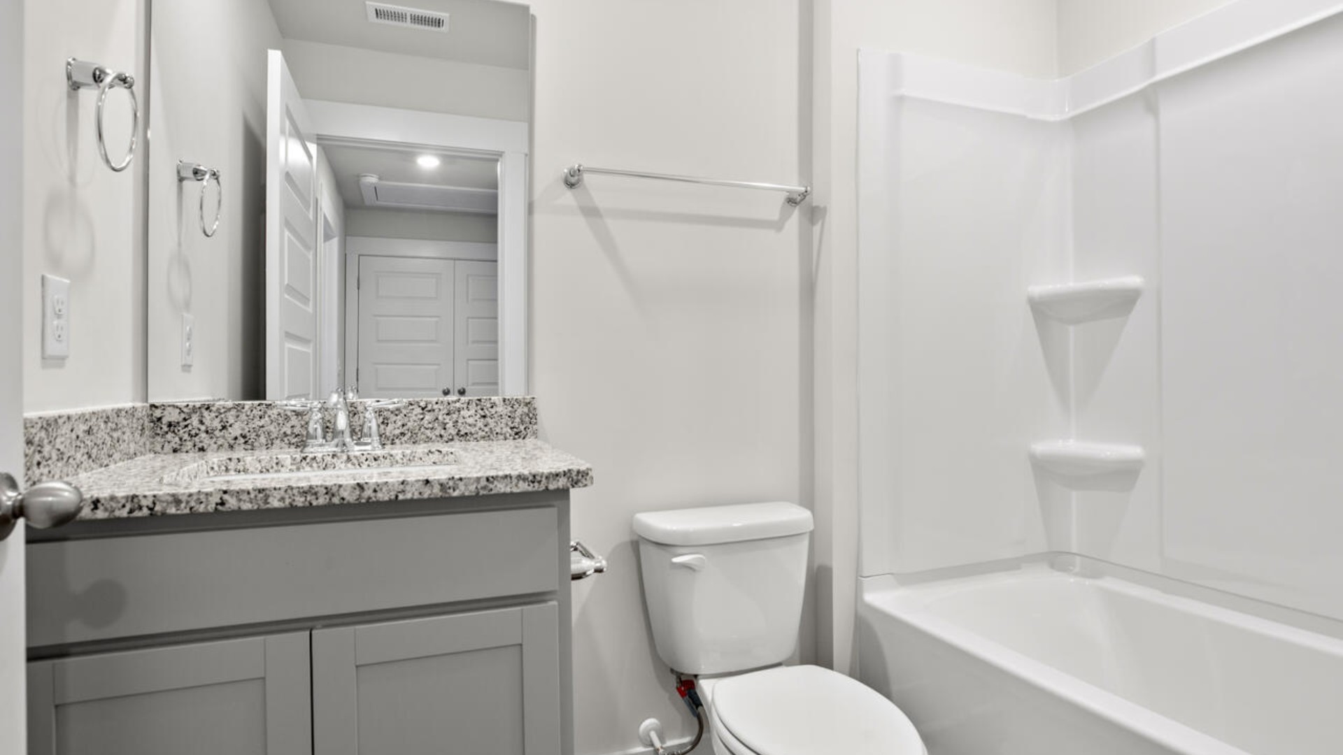 It also includes two additional bedrooms, a shared bathroom, and a laundry room for convenience. The bathrooms are equally elegant, featuring matching granite and a primary suite with a glass shower that feels like your own personal spa.