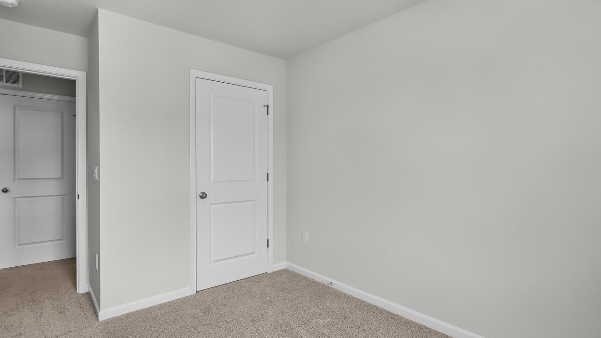 The second floor features the primary bedroom with a walk-in closet and double vanities. It also includes two additional bedrooms, a shared bathroom, and a laundry room for convenience.
