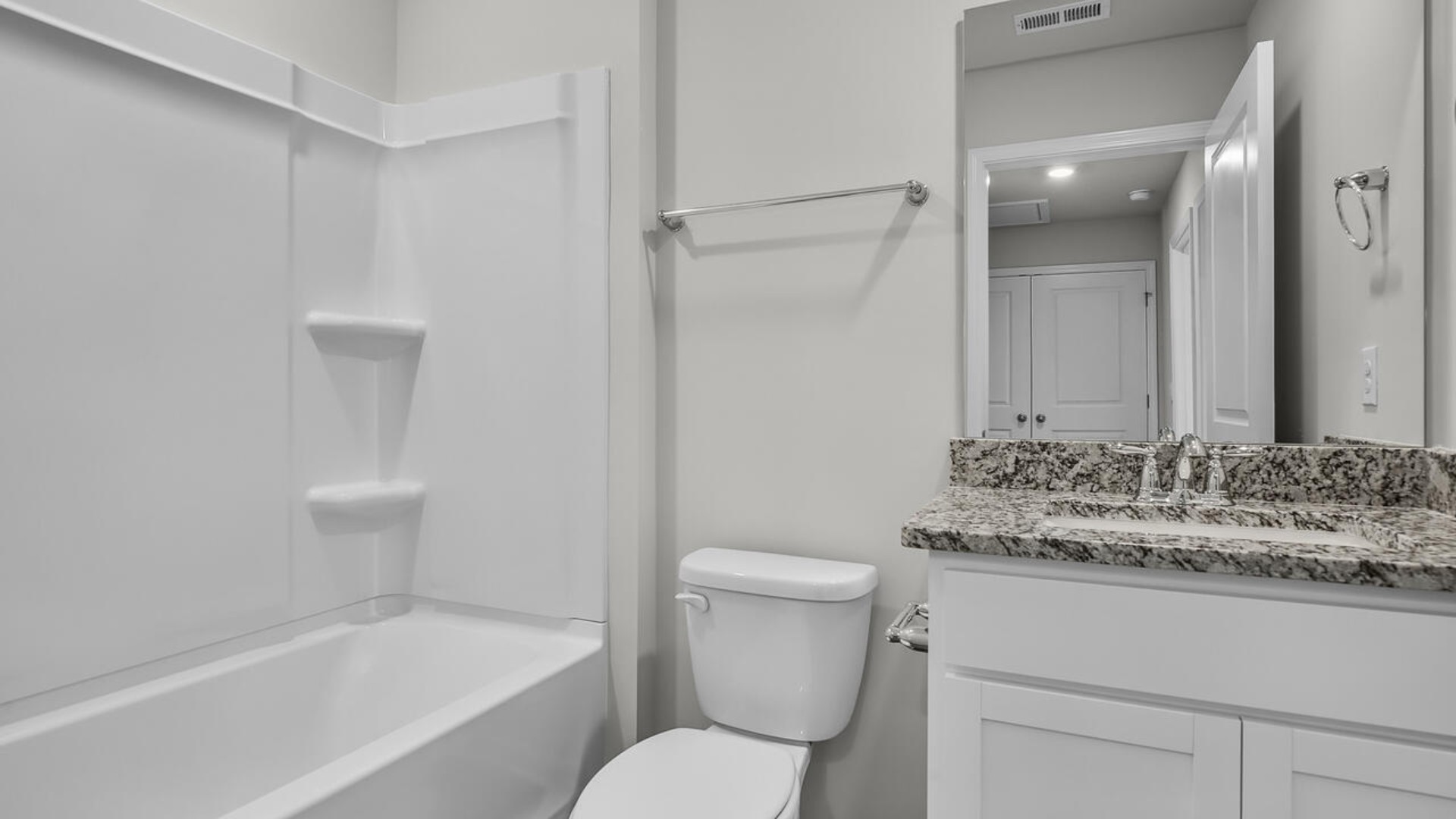 The second floor features the primary bedroom with a walk-in closet and double vanities. It also includes two additional bedrooms, a shared bathroom, and a laundry room for convenience.