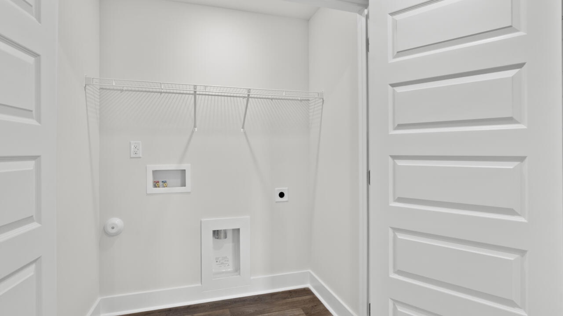 The second floor features the primary bedroom with a walk-in closet and double vanities. It also includes two additional bedrooms, a shared bathroom, and a laundry room for convenience