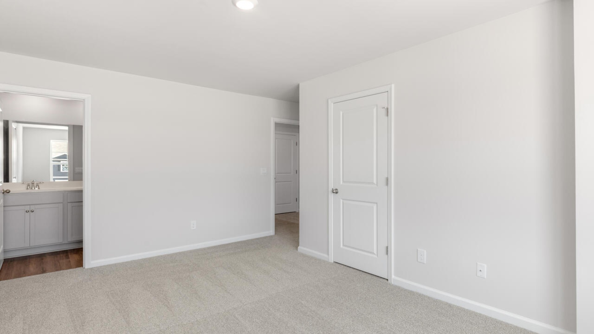 The second floor features the primary bedroom with a walk-in closet and double vanities. It also includes two additional bedrooms, a shared bathroom, and a laundry room for convenience.