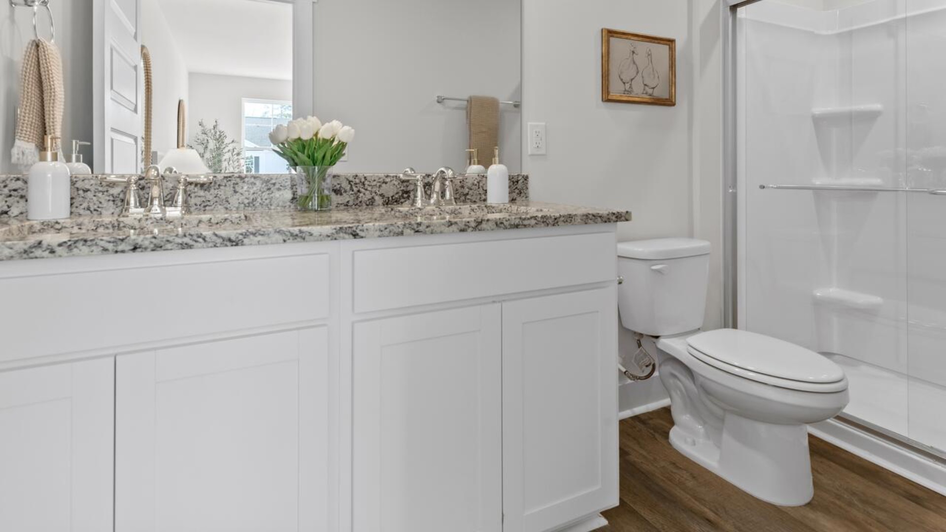 he second floor features the primary bedroom with a walk-in closet and double vanities.