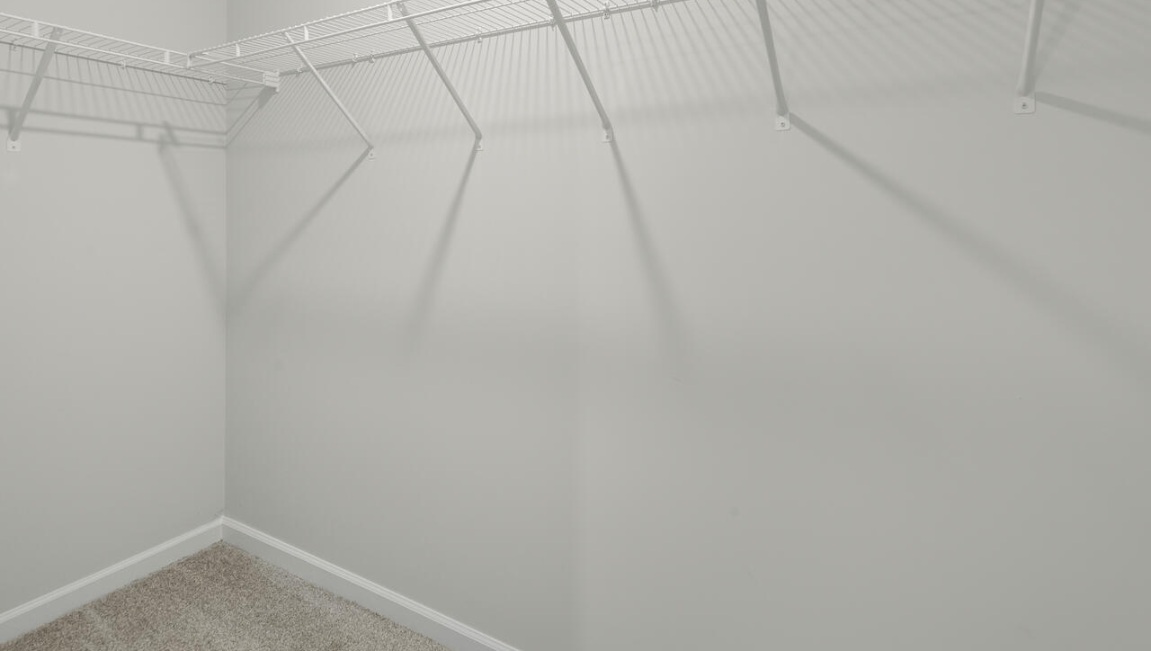 The second floor features the primary bedroom with a walk-in closet and double vanities. It also includes two additional bedrooms, a shared bathroom, and a laundry room for convenience.