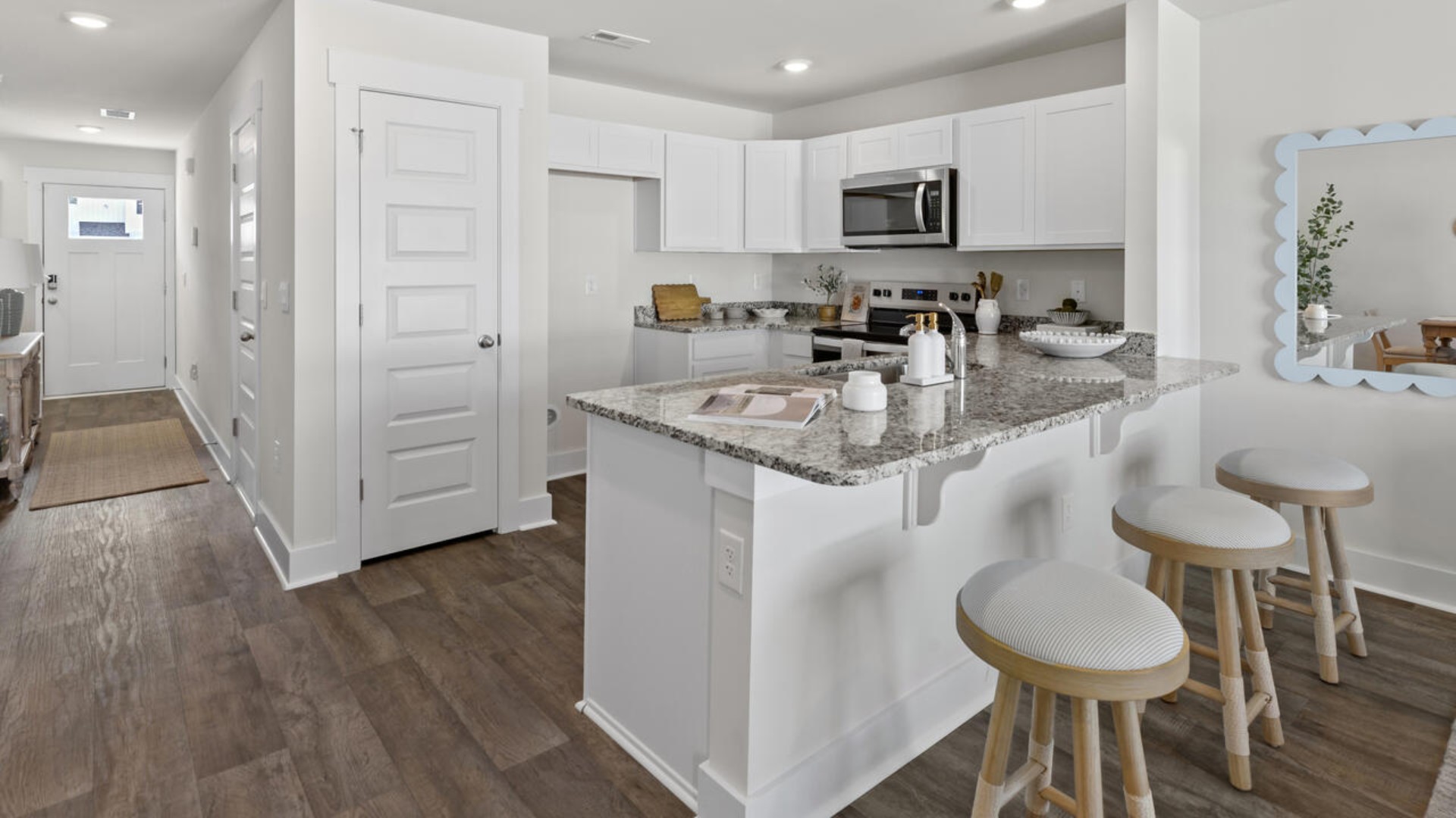 On the first floor, you'll find a spacious kitchen that flows into a light-filled living area, perfect for hosting guests. The kitchen overlooks the dining and living spaces, ideal for entertaining guests or enjoying family time while preparing meals with new stainless-steel appliances and granite countertops. You’ll never be too far from the action with the living and dining area right there.