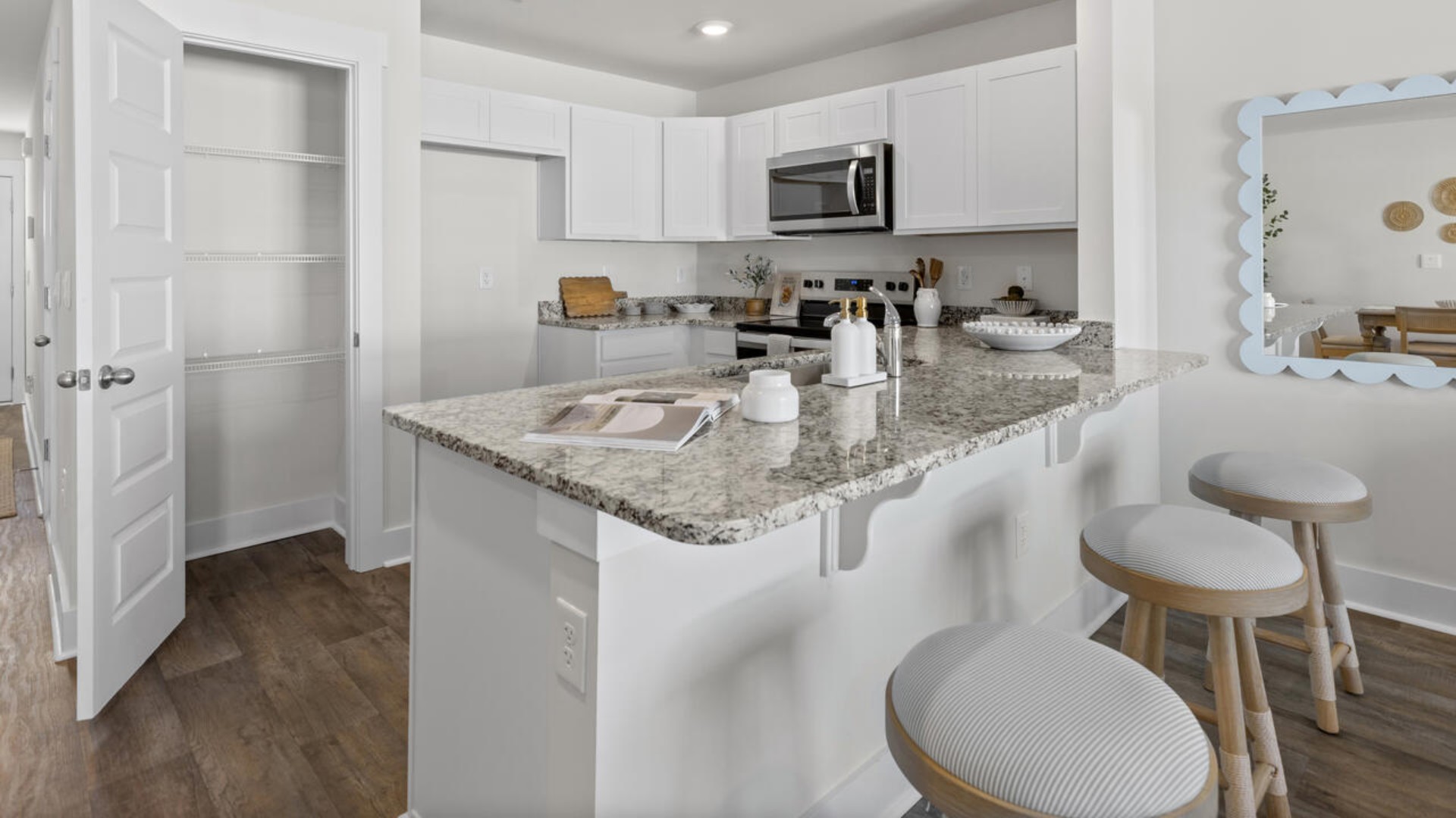 On the first floor, you'll find a spacious kitchen that flows into a light-filled living area, perfect for hosting guests. The kitchen overlooks the dining and living spaces, ideal for entertaining guests or enjoying family time while preparing meals with new stainless-steel appliances and granite countertops. You’ll never be too far from the action with the living and dining area right there.