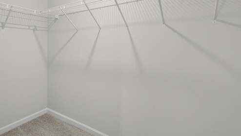 The second floor features the primary bedroom with a walk-in closet and double vanities