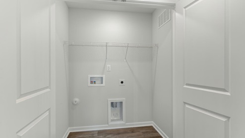 It also includes two additional bedrooms, a shared bathroom, and a laundry room for convenience.