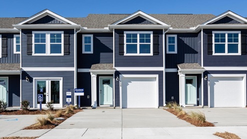 The Pearson is a two-story floor plan with a single-car garage. The kitchen overlooks the dining and living spaces