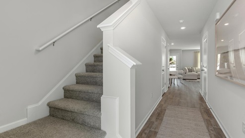 The Pearson is a two-story floor plan with a single-car garage. The kitchen overlooks the dining and living spaces