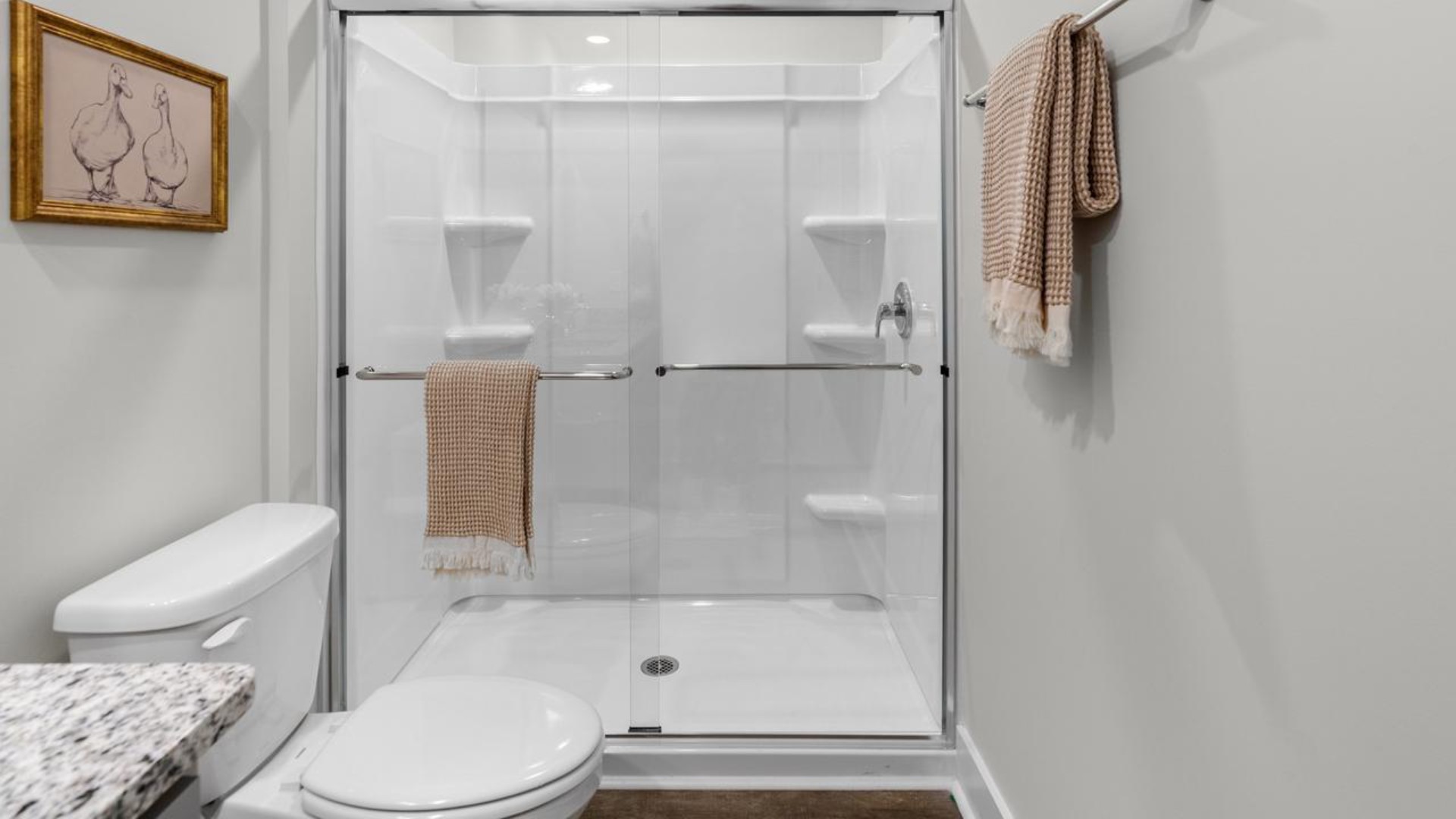 The second floor features the primary bedroom with a walk-in closet and double vanities. It also includes two additional bedrooms, a shared bathroom, and a laundry room for convenience.
