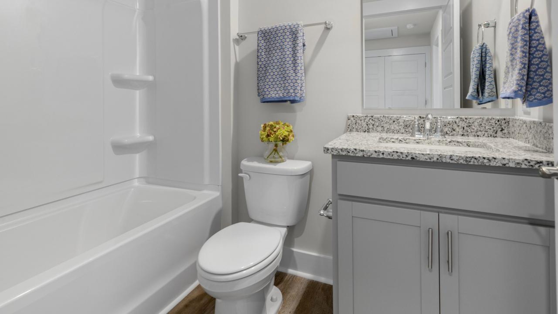 The second floor features the primary bedroom with a walk-in closet and double vanities. It also includes two additional bedrooms, a shared bathroom, and a laundry room for convenience.