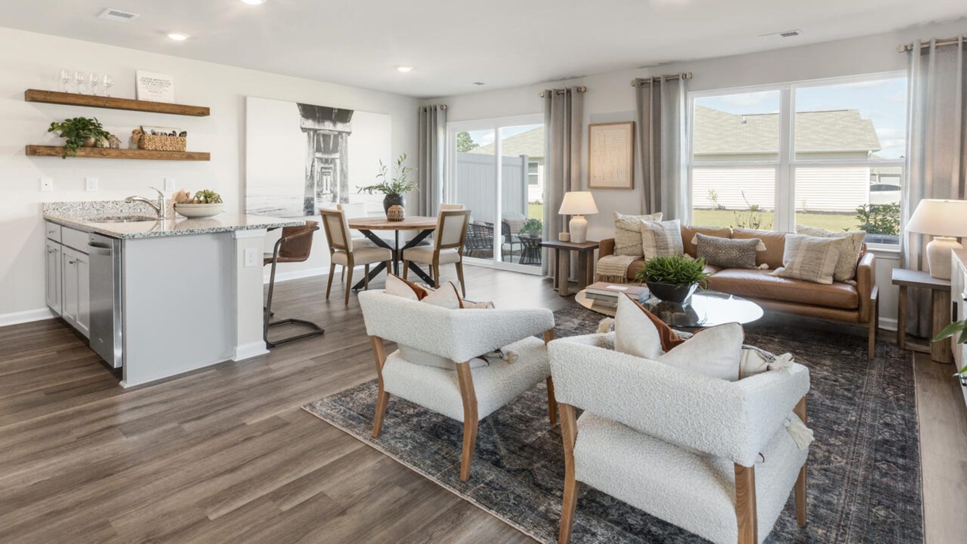 The kitchen features shaker-style cabinets, granite countertops, and stainless steel appliances, which are sure to both turn heads and make meal prep easy. You’ll never be too far from the action with the living and dining area right there.