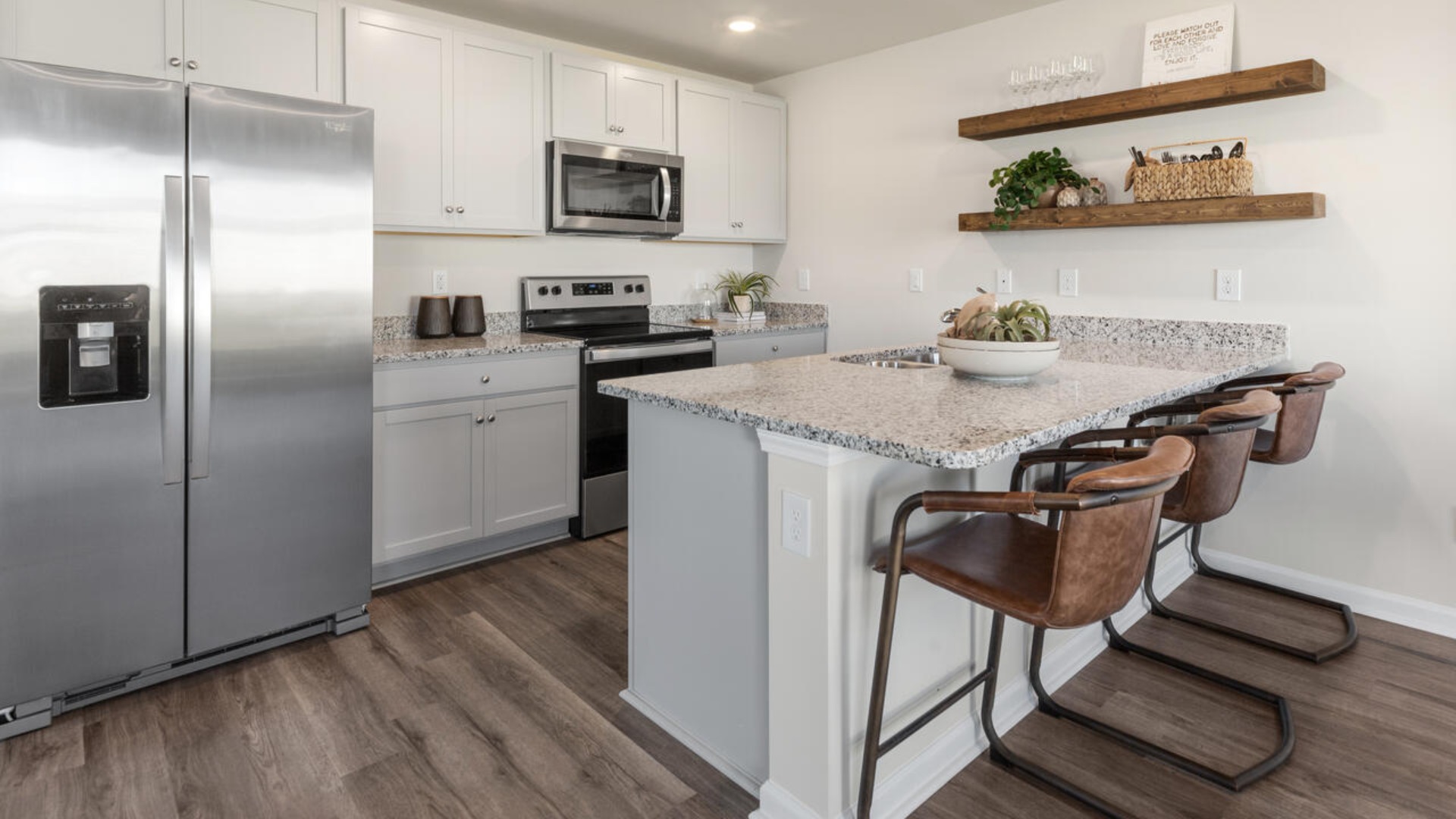 The kitchen features shaker-style cabinets, granite countertops, and stainless steel appliances, which are sure to both turn heads and make meal prep easy. You’ll never be too far from the action with the living and dining area right there.