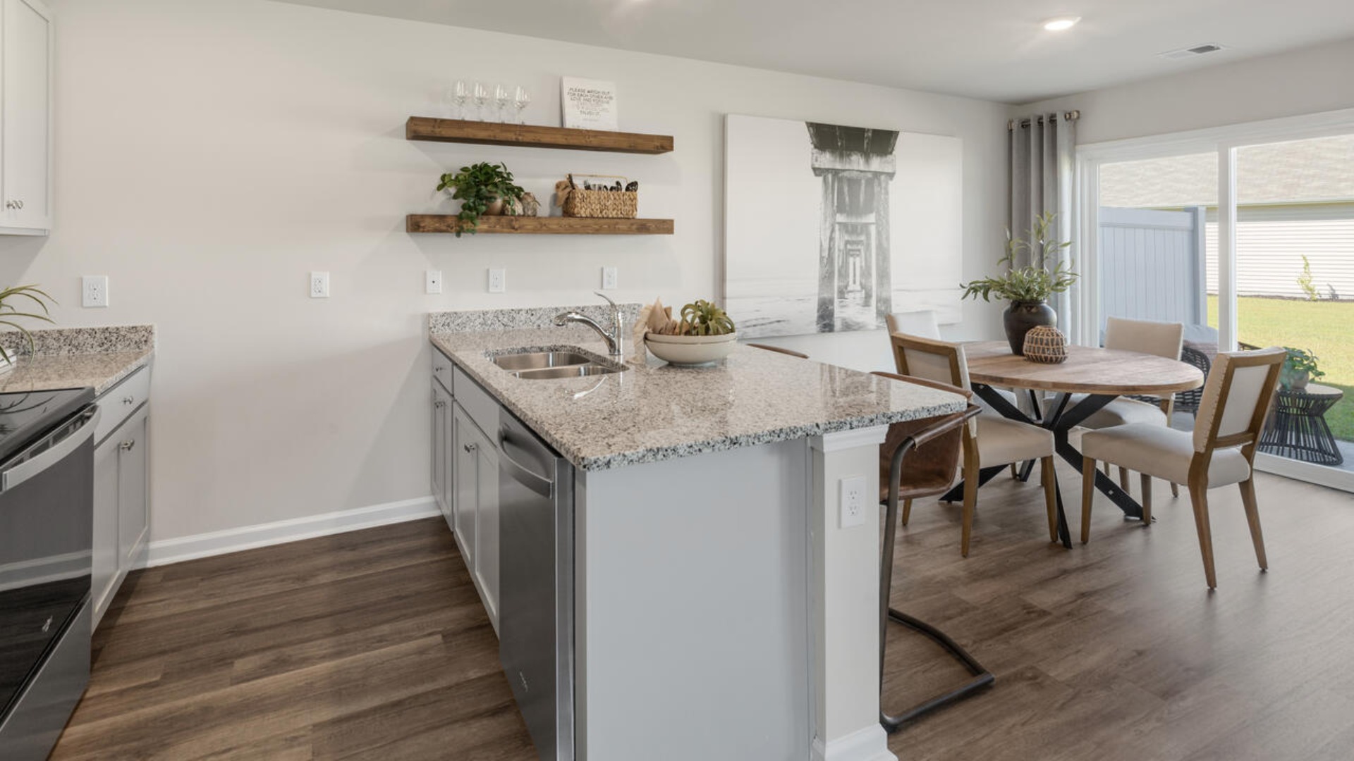 The kitchen features shaker-style cabinets, granite countertops, and stainless steel appliances, which are sure to both turn heads and make meal prep easy. You’ll never be too far from the action with the living and dining area right there.