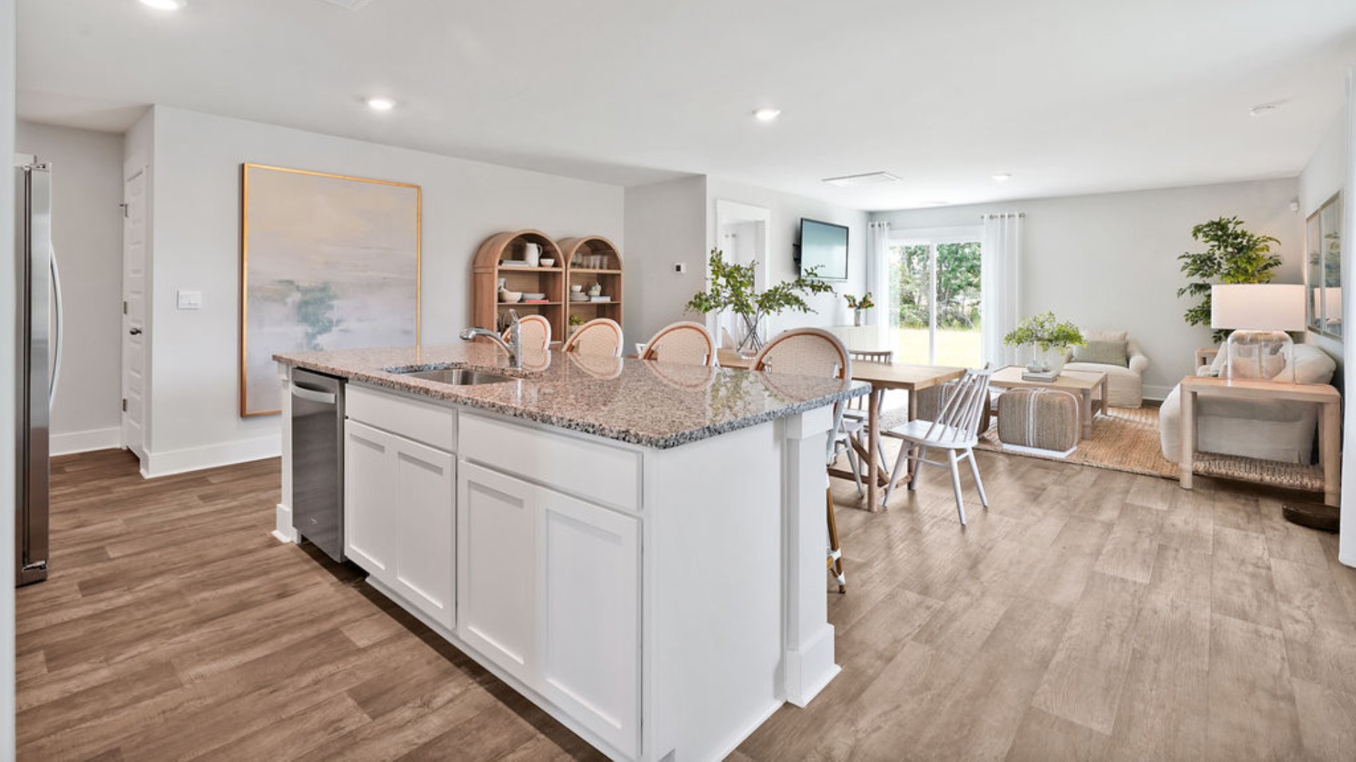 The kitchen features beautiful cabinets, granite countertops, and stainless steel appliances, which are sure to both turn heads and make meal prep easy. You’ll never be too far from the action with the living and dining area right there.