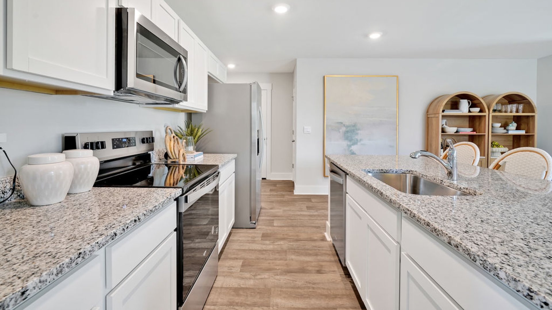 The kitchen features beautiful cabinets, granite countertops, and stainless steel appliances, which are sure to both turn heads and make meal prep easy. You’ll never be too far from the action with the living and dining area right there.