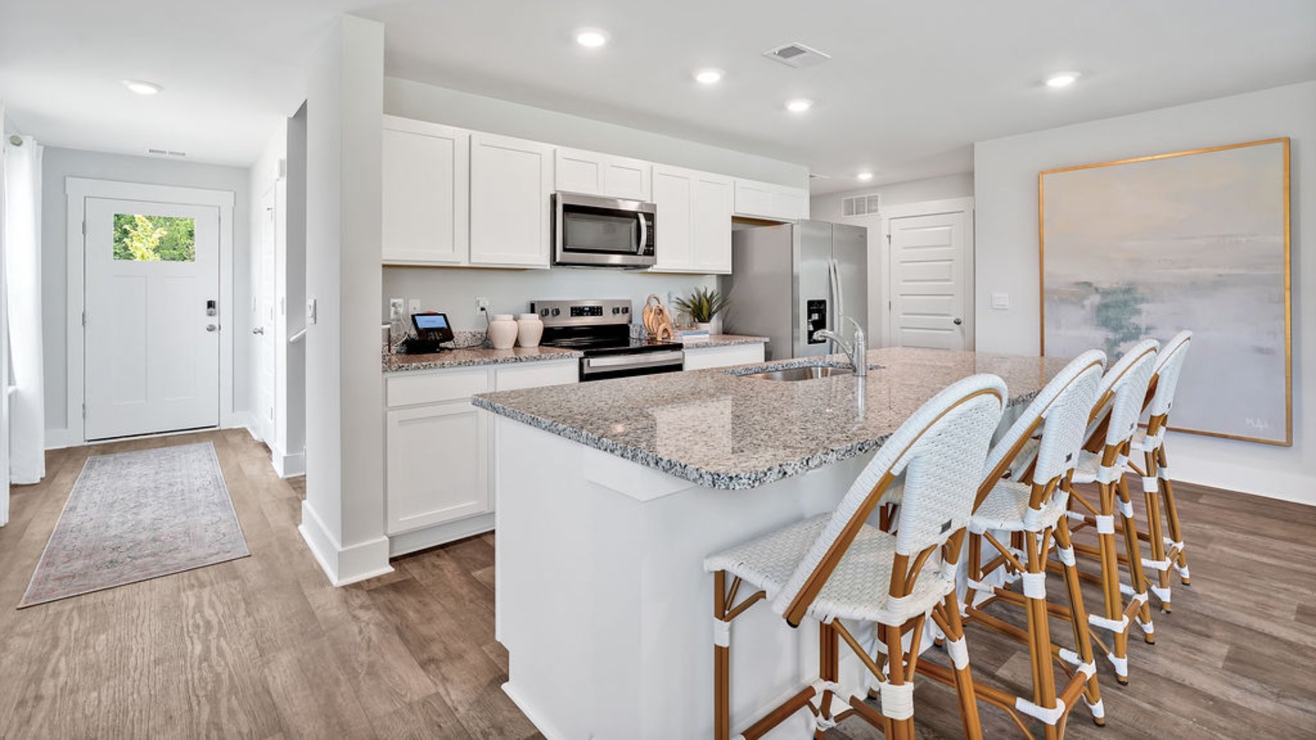 The kitchen features beautiful cabinets, granite countertops, and stainless steel appliances, which are sure to both turn heads and make meal prep easy. You’ll never be too far from the action with the living and dining area right there.