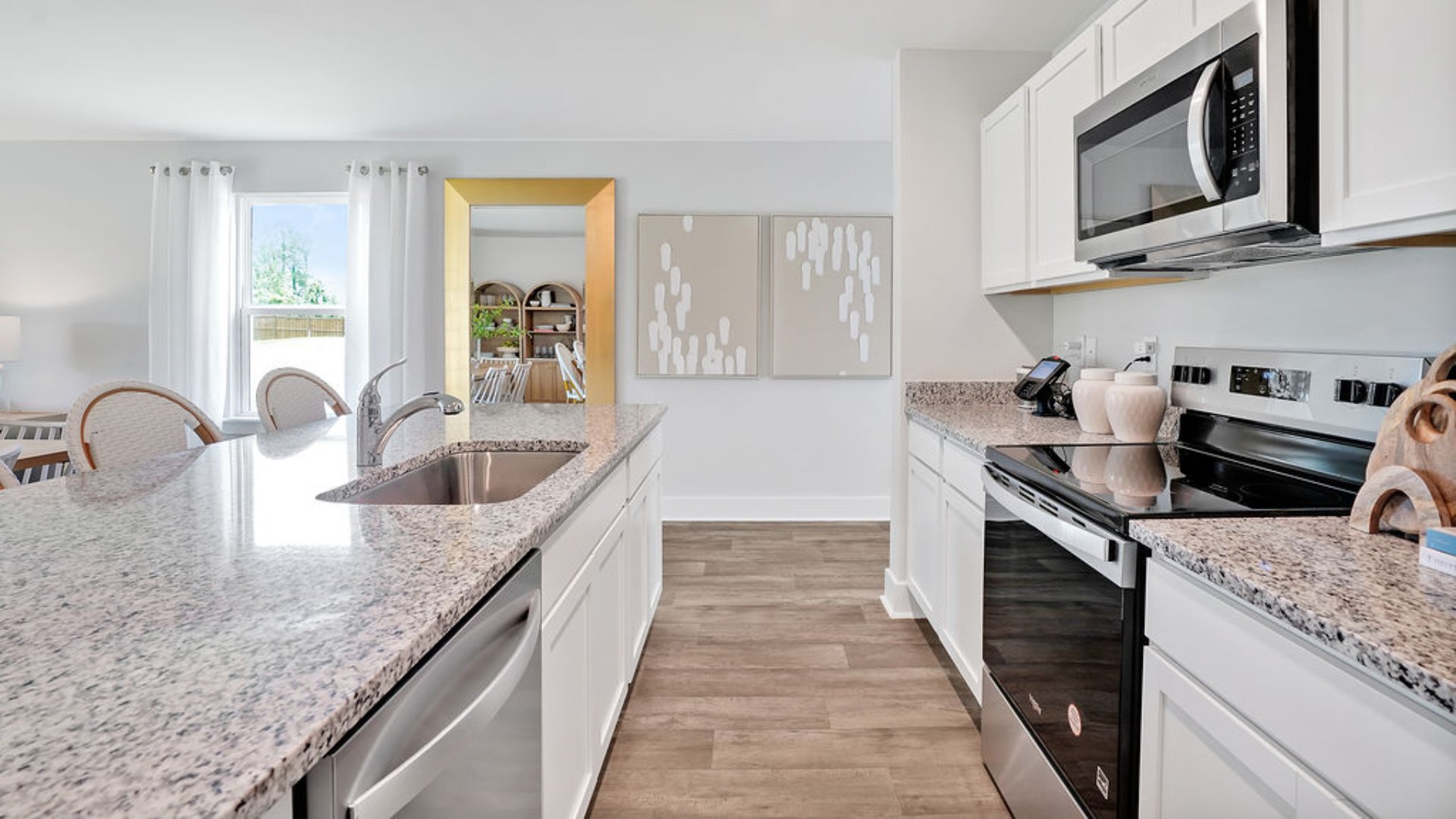 The kitchen features beautiful cabinets, granite countertops, and stainless steel appliances, which are sure to both turn heads and make meal prep easy. You’ll never be too far from the action with the living and dining area right there.