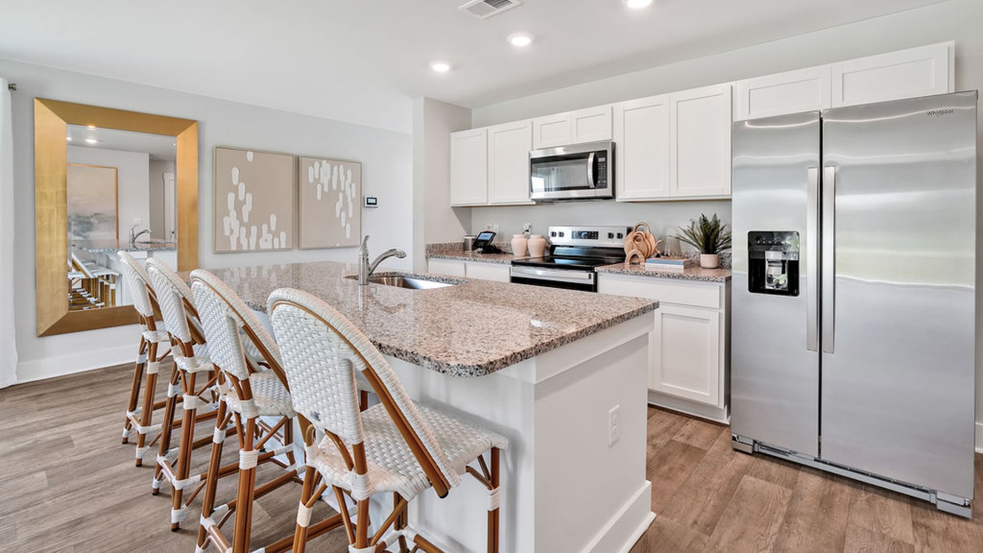 The kitchen features beautiful cabinets, granite countertops, and stainless steel appliances, which are sure to both turn heads and make meal prep easy. You’ll never be too far from the action with the living and dining area right there.