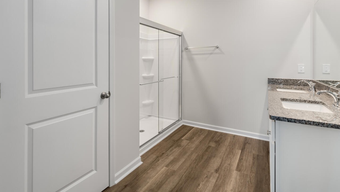 The Primary Suite offers a massive closet and a luxurious bathroom with a walk-in shower, linen closet, and dual vanity.