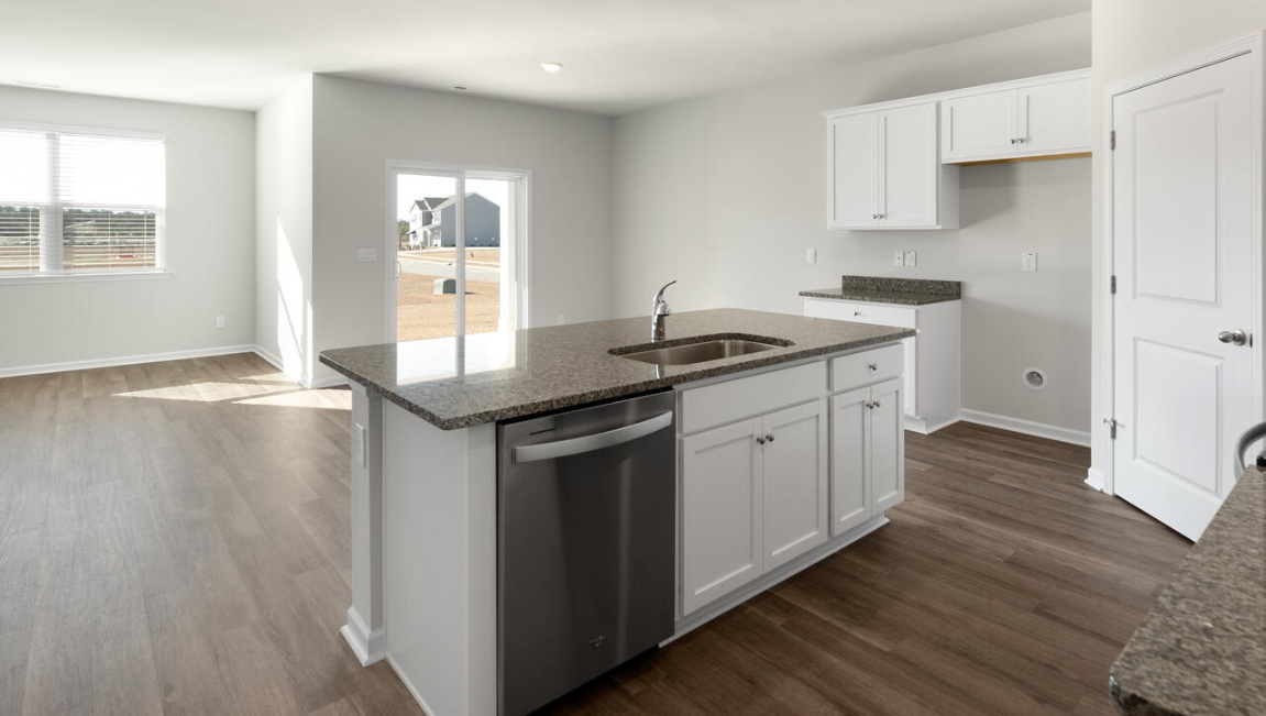 The kitchen features beautiful cabinets, granite countertops, and stainless steel appliances, which are sure to both turn heads and make meal prep easy. You’ll never be too far from the action with the living and dining area right there.