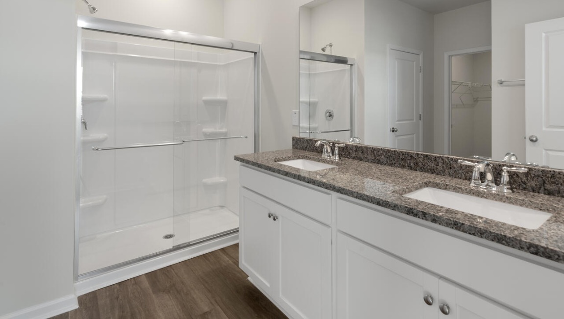 The primary bedroom has its own attached bathroom that features a walk-in closet and all the space you need to get ready in the morning