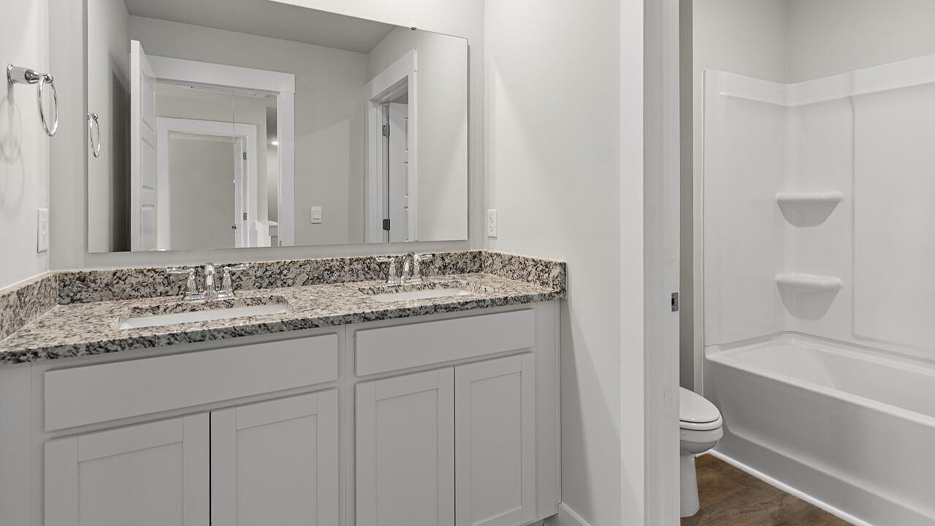 Upstairs, you will find three additional bedrooms with a shared full bathroom and a functional living space.