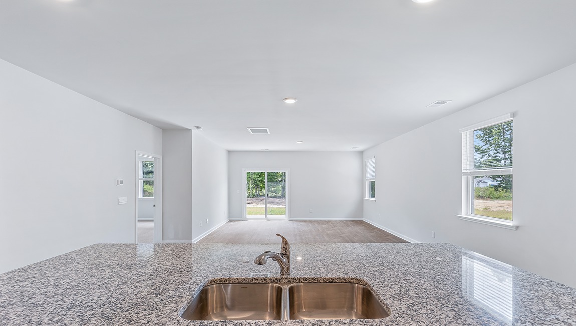 This beautiful kitchen features granite counters, stainless steel appliances, a large kitchen island with room for 4 counter height barstools and there's a pantry too.