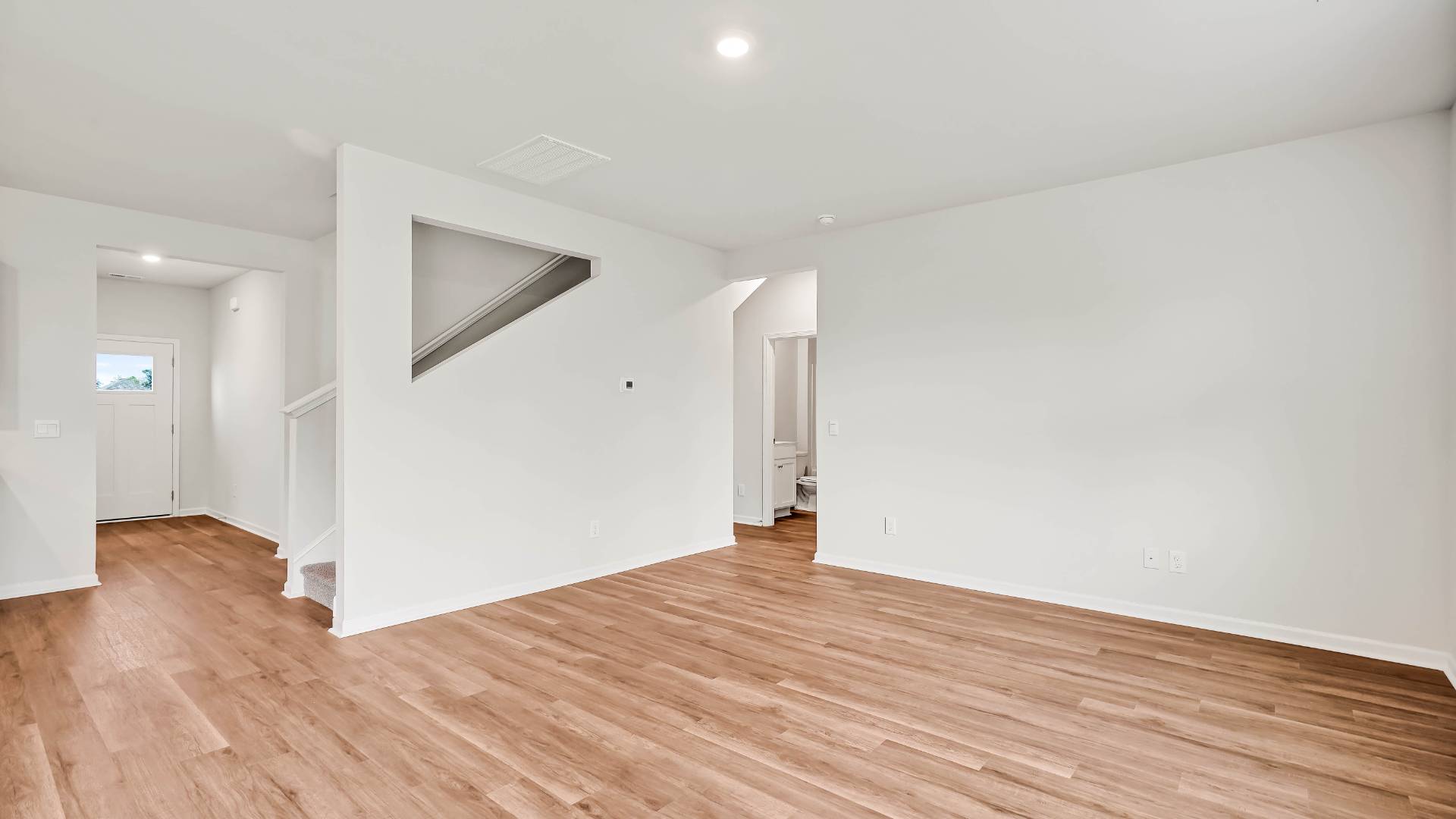 The open-concept kitchen features granite countertops and stainless steel appliances. The kitchen seamlessly connects to the dining and living areas, creating a great space for entertainment