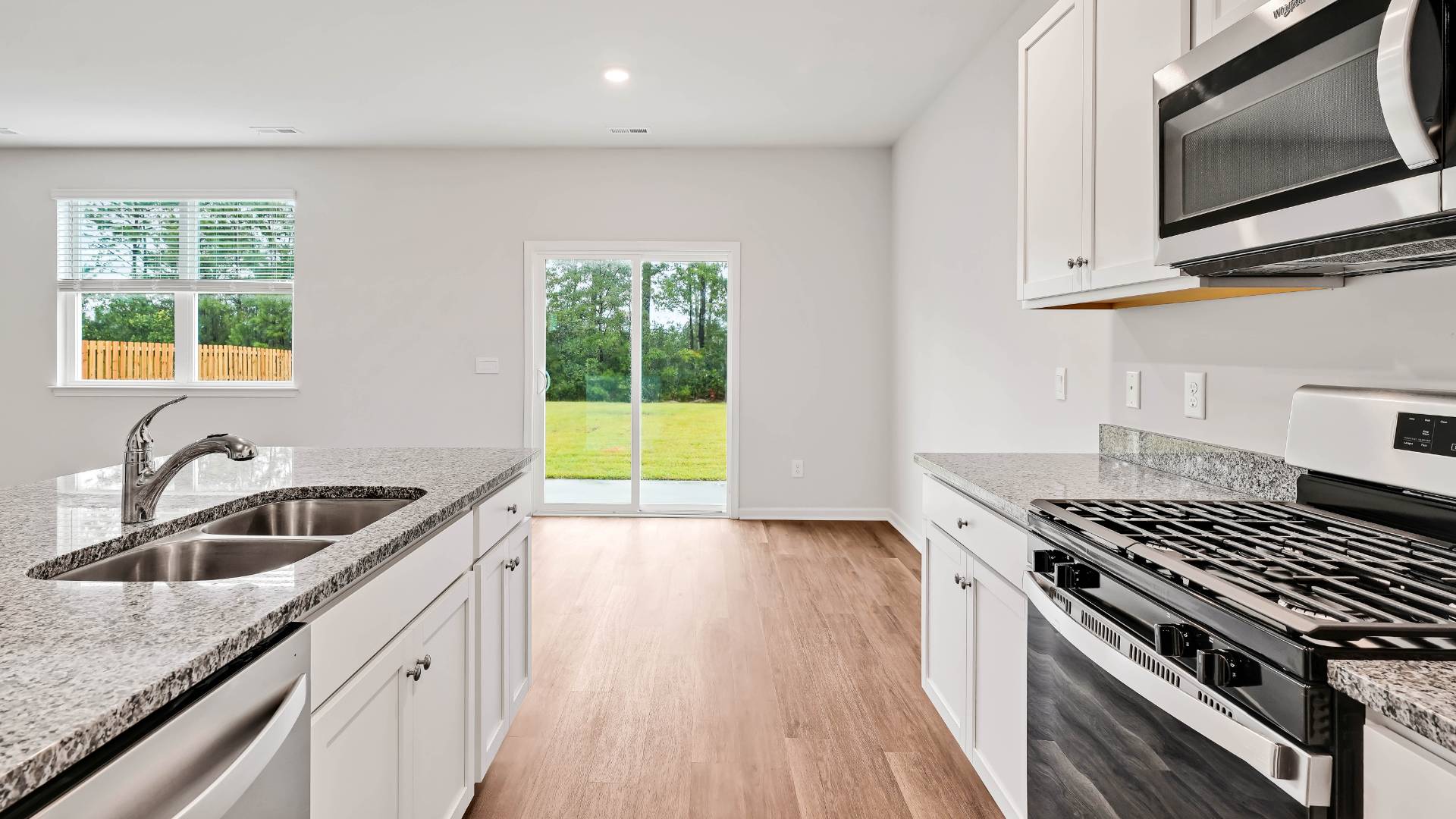 The open-concept kitchen features granite countertops and stainless steel appliances. The kitchen seamlessly connects to the dining and living areas, creating a great space for entertainment