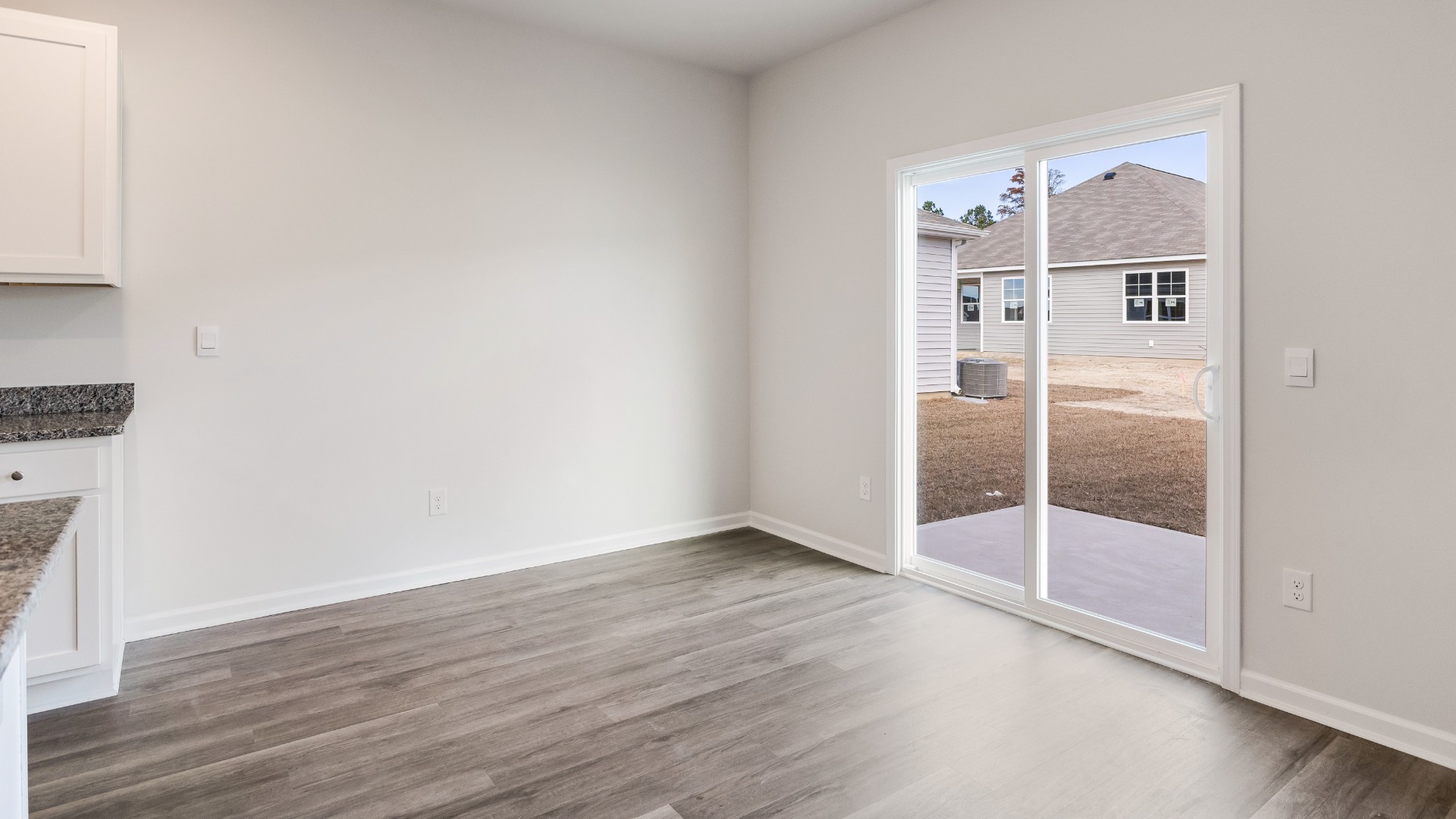 The open-concept kitchen features granite countertops and stainless steel appliances. The kitchen seamlessly connects to the dining and living areas, creating a great space for entertainment.