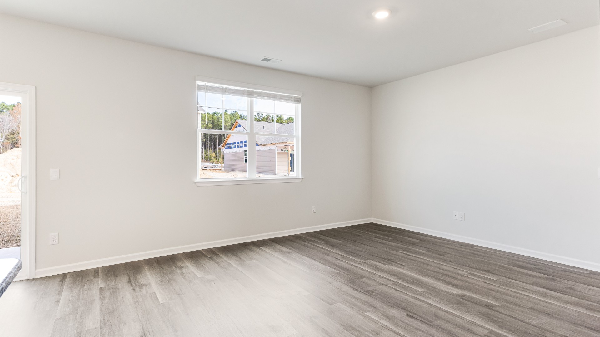 The open-concept kitchen features granite countertops and stainless steel appliances. The kitchen seamlessly connects to the dining and living areas, creating a great space for entertainment.