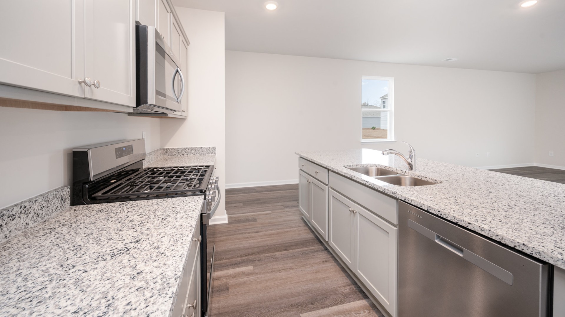 The kitchen features beautiful cabinets, granite countertops, and stainless steel appliances, which are sure to both turn heads and make meal prep easy. You’ll never be too far from the action with the living and dining area right there.